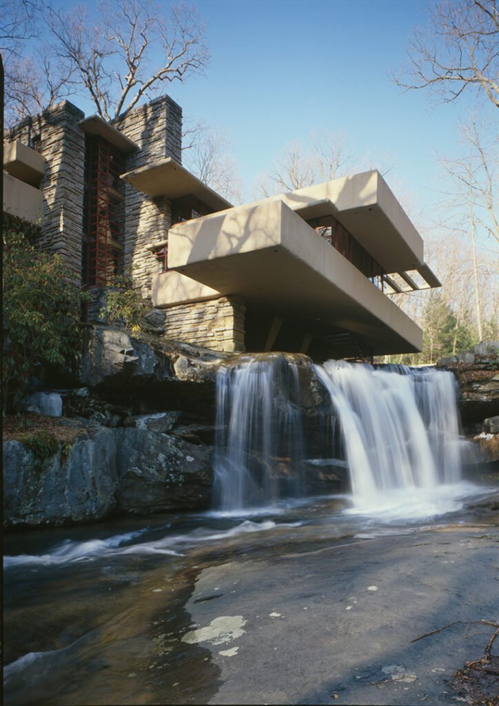 Fallingwater house blending into natural landscape over a waterfall.